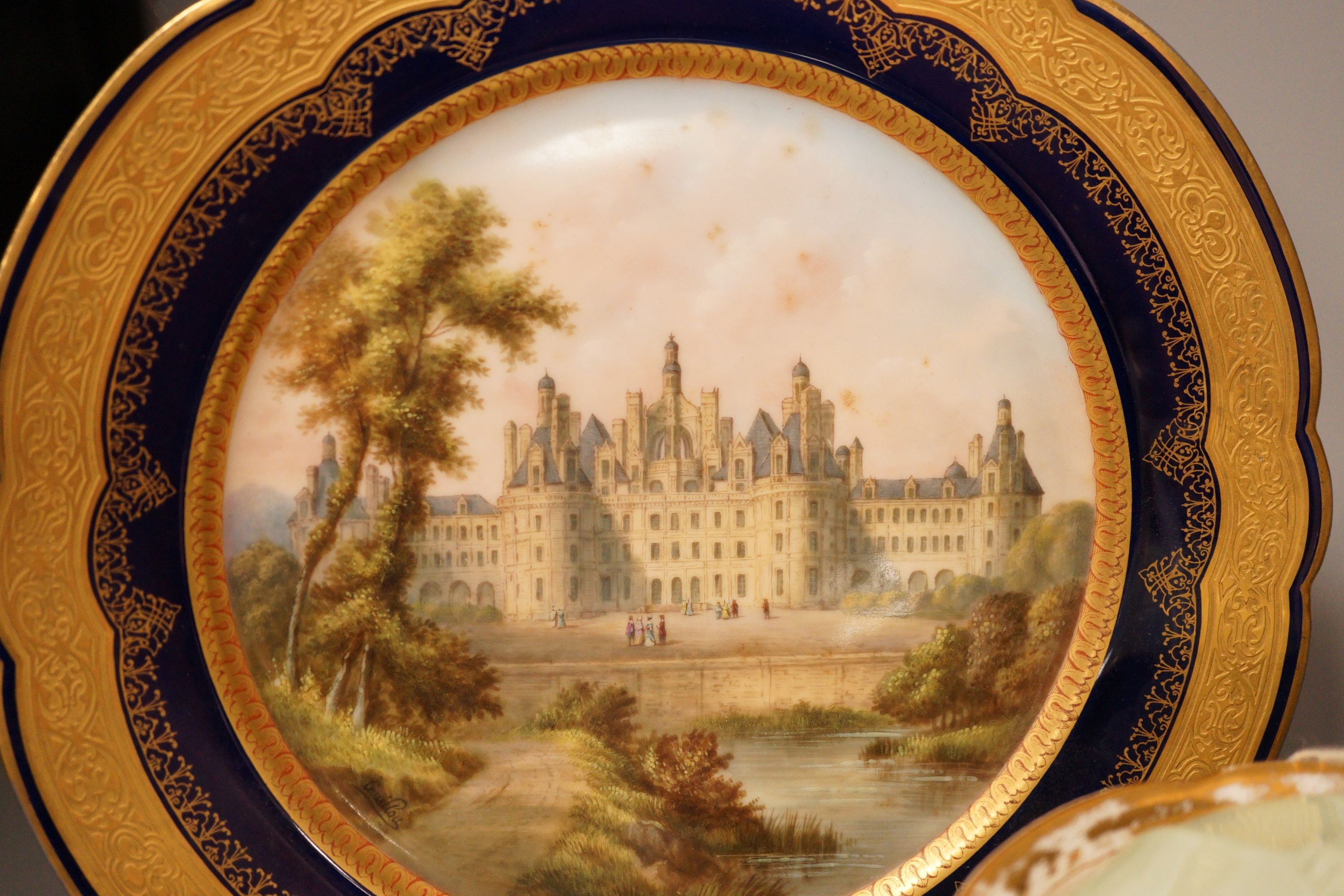 A 19th century Meissen sucrier, a Sevres style Chateau de Chambord plate and a pair of Paris porcelain scent bottles